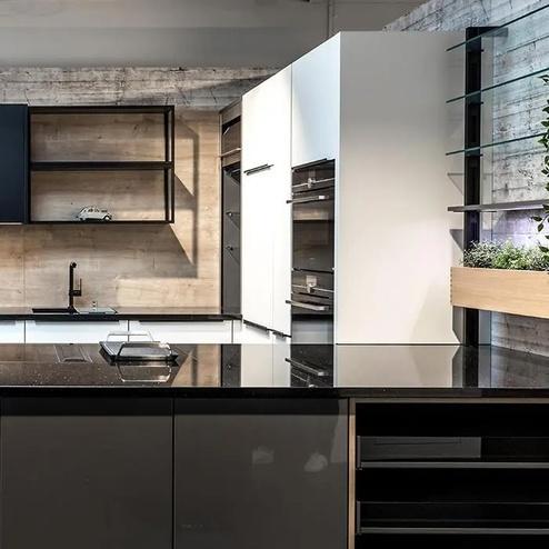 Moderne Küche mit schwarzen Akzenten und Holzdetails Stilvolle Küche mit schwarzer Arbeitsplatte, offenen Regalen, Holzrückwand und integrierten weissen Schränken. Begrünungselemente ergänzen das Design.